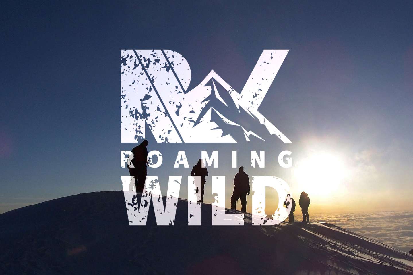 Roaming Wild logo placed over image of hikers climing a ridge