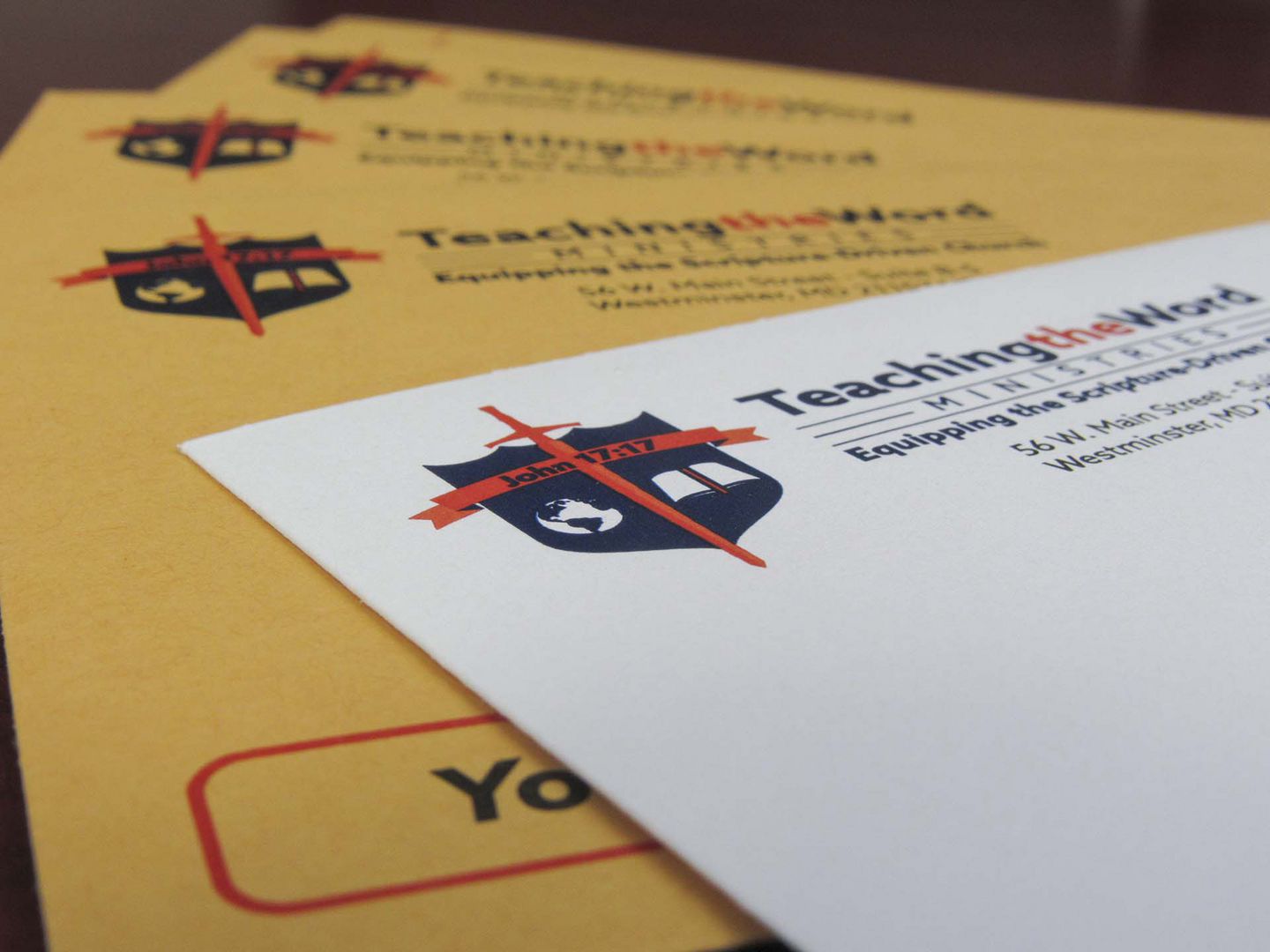 The TeachingTheWord logo printed on several envelopes.