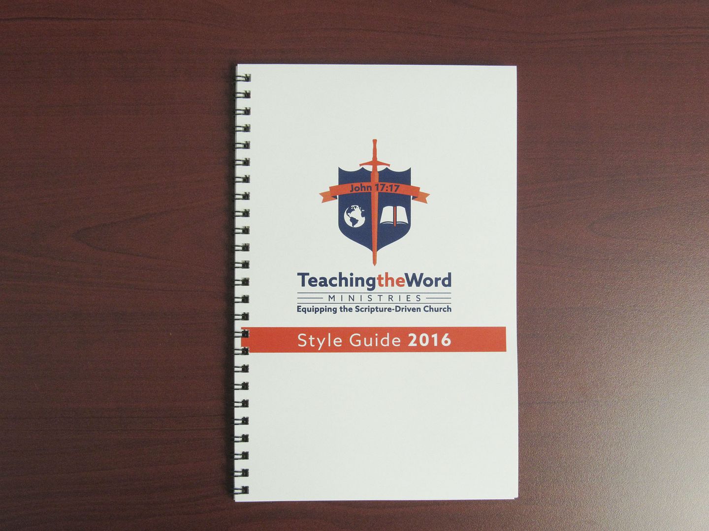 The completed, spiral-bound style guide booklet laying on a table.