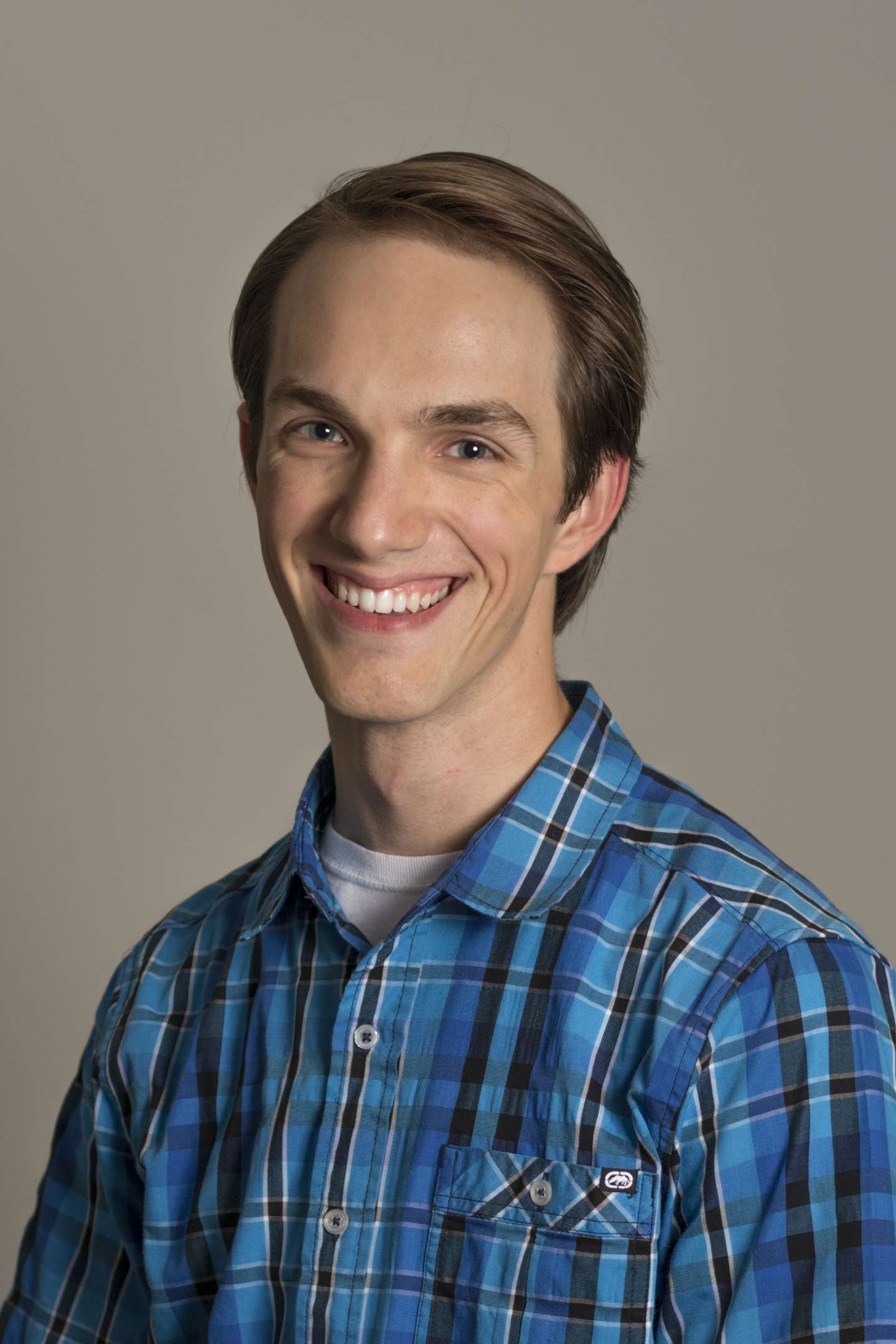 Portrait of David Klein wearing a blue plaid button down shirt.
